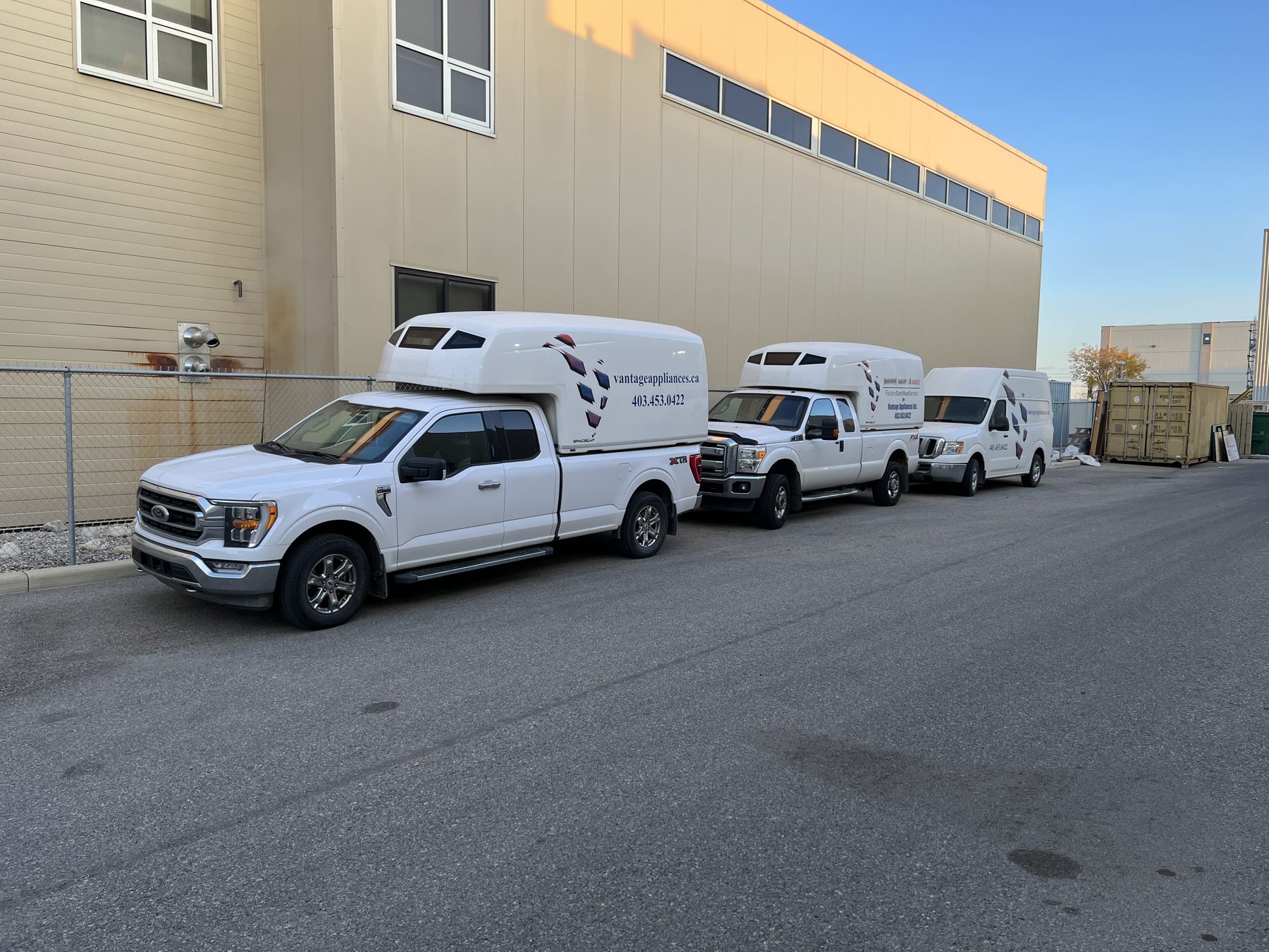 Three Vantage service trucks parked outside the service centre